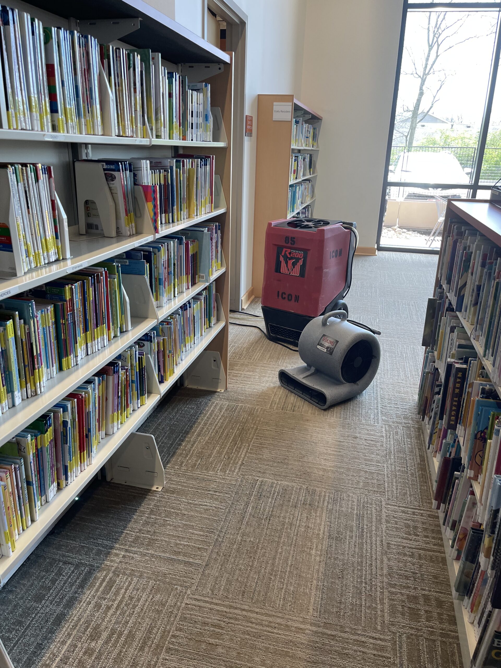 Professional drying equipment positioned in a public library aisle near Mason